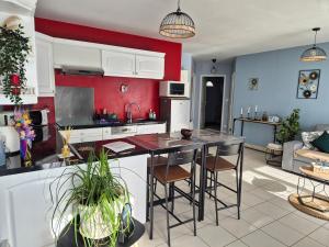 a kitchen with a table and chairs in a room at Maison chaleureuse au calme in Domérat