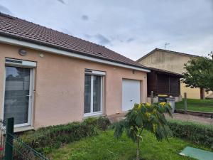 a house with a grass yard in front of it at Maison chaleureuse au calme in Domérat