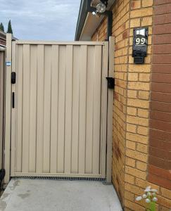 a gate in a house with a driveway at The Melbourne Private Room - Driveway Parking in Craigieburn +31 photos