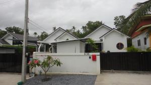 een wit huis met een zwart hek bij Waan Samui Pool Villa 2 in Taling Ngam Beach