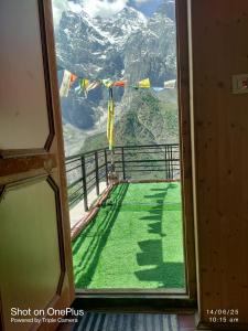 a room with a window with a view of a mountain at Shugu a village home stay in Gondla