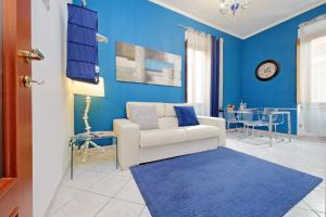 a living room with a white couch and a blue wall at Luxury Domus in Rome