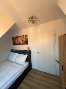 a bedroom with a bed and a ceiling at FeWo Foorden Wohnglück 4 in Hesel
