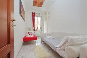 a bedroom with a bed and a red chair at Luxury Domus in Rome