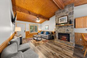 a living room with a stone fireplace at On Dolly Time Slow Down and Stay Awhile in Pigeon Forge