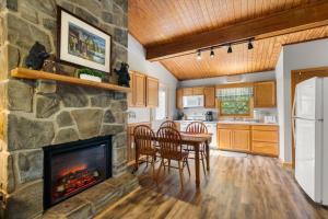 a kitchen with a stone fireplace and a table and chairs at On Dolly Time Slow Down and Stay Awhile in Pigeon Forge +7 photos