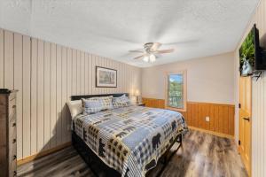 a bedroom with a bed and a ceiling fan at On Dolly Time Slow Down and Stay Awhile in Pigeon Forge