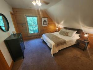 a bedroom with a large bed and a window at Wilderness retreat in Marion