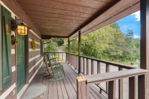 a porch with chairs and a bench on a house at On Dolly Time Slow Down and Stay Awhile in Pigeon Forge