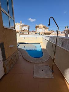 a swimming pool on the balcony of a house at Casa iris in San Miguel de Salinas