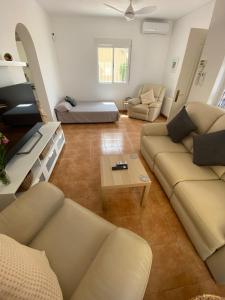 a living room with couches and a coffee table at Casa iris in San Miguel de Salinas