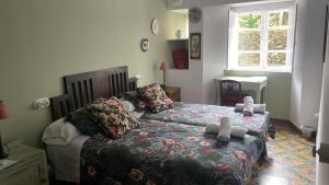 a bedroom with a bed with stuffed animals on it at Camino de Estrellas Mondoñedo Lugo in Mondoñedo