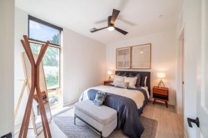 a bedroom with a bed and a chair and windows at Inkwell Charlotte in Charlotte +94 photos