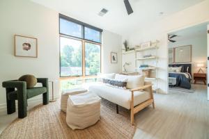 a living room with a couch and a chair at Inkwell Charlotte in Charlotte
