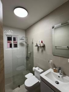 a bathroom with a toilet and a sink and a shower at Paradise away from home in Punta Cana +16 photos