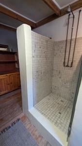 a shower with a glass door in a bathroom at Crescent Cottage Fish Hoek in Cape Town