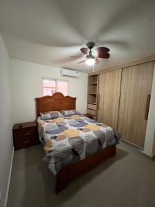 a bedroom with a bed and a ceiling fan at Paradise away from home in Punta Cana