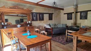a living room with a table and a couch at Crescent Cottage Fish Hoek in Cape Town