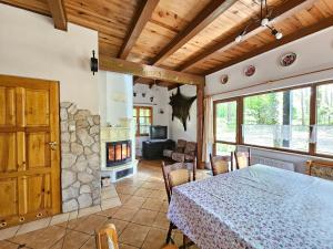 a living room with a table and a fireplace at Villa Jolanta in Teerau