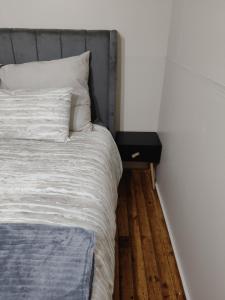 a bedroom with a bed and a night stand next to it at The Man Cave Extension in Sabie +7 photos