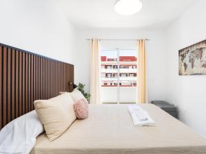 a bedroom with a large bed with a window at Puertito Azul in Puertito de Güímar +19 photos