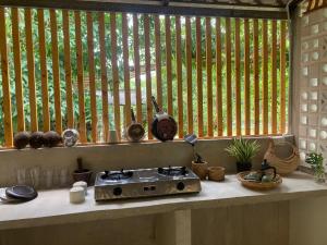 a kitchen counter with a stove in front of a window at Bann Seamé in Ban Khlong Kloi +19 photos