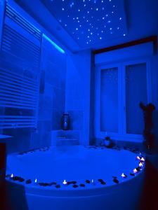 a blue room with a bed with lights on it at "Glamappartspa" So cosy Champagne offert & Parking in Dijon +15 photos