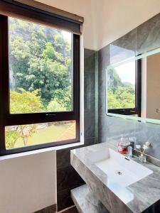 a bathroom with a sink and a large window at Trang An Hana homestay in Nguyên Ngoại