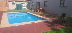 a swimming pool in the backyard of a house at Achimer at 44 in Welkom