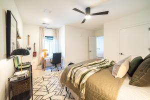 a bedroom with a bed and a ceiling fan at Inkwell Charlotte in Charlotte
