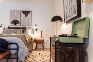 a bedroom with a bed and a computer on a table at Inkwell Charlotte in Charlotte