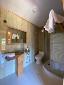 a bathroom with a sink and a toilet and a shower at Hotel Boutique La Casa de Coco in Gorbea