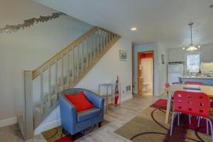 a living room with a blue chair and a staircase at 13 Lodge in Hood River