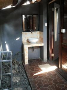 a bathroom with a sink and a mirror at Radya Homestay in Nusa Lembongan