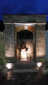 a house with lights in the doorway at night at Radya Homestay in Nusa Lembongan