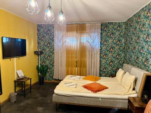 a bedroom with a bed and a tv in it at Chic Home in Sibiu
