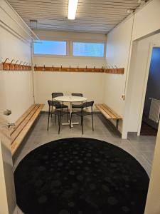 a room with a table and chairs in it at Hjortens vandrarhem in Herräng