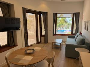 a living room with a table and a couch at Canovas Nerja - Oasis de Capistrano in Nerja