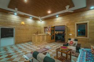 a living room with a couch and a table at Gj02 desert resort in Sām