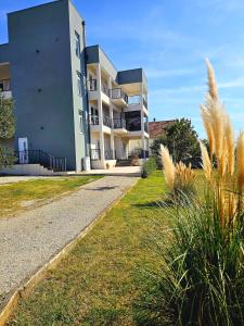 a large apartment building with a pathway in front of it at Apartments Royal Holiday in Bibinje