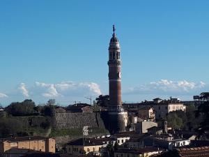 a tall tower on top of a city at La nuova casa di Giove in Palazzolo sullʼOglio
