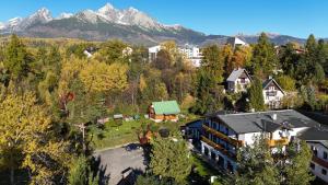 an aerial view of a house with mountains in the background at Penzion Pažický in Tatranská Lomnica