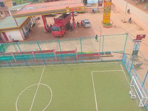 a tennis court in front of a building at Unique suites apartments in Mukono