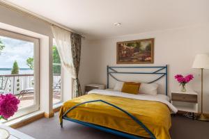 a bedroom with a bed and a large window at Slėnis Trakuose in Trakai