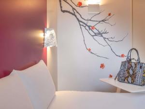 a bedroom with a bed with a pillow and a lamp at Mercure Le Mans Batignolles - Hotel & Spa in Le Mans +58 photos