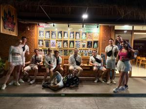 a group of people sitting in front of a restaurant at U OLIVE Hotel in Ban Nua