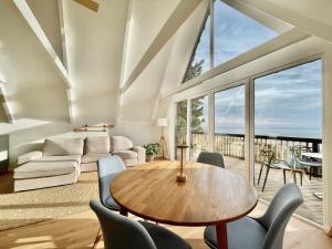 a living room with a table and chairs at Black Pine Cabin in Szentendre