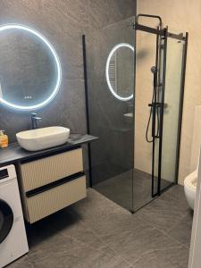 a bathroom with a shower with a sink and a toilet at Pokoje Warszawski Świt in Warsaw +22 photos