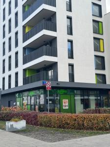 a building with a store in front of it at Pokoje Warszawski Świt in Warsaw