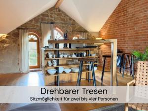 a kitchen with a brick wall and wooden shelves at HexenburgbeiDresden 2 Zimmer Architektenwohnung mit eigener Sauna, Whirlwanne und Kamin - Nähe Sächsische Schweiz Dresden in Großharthau